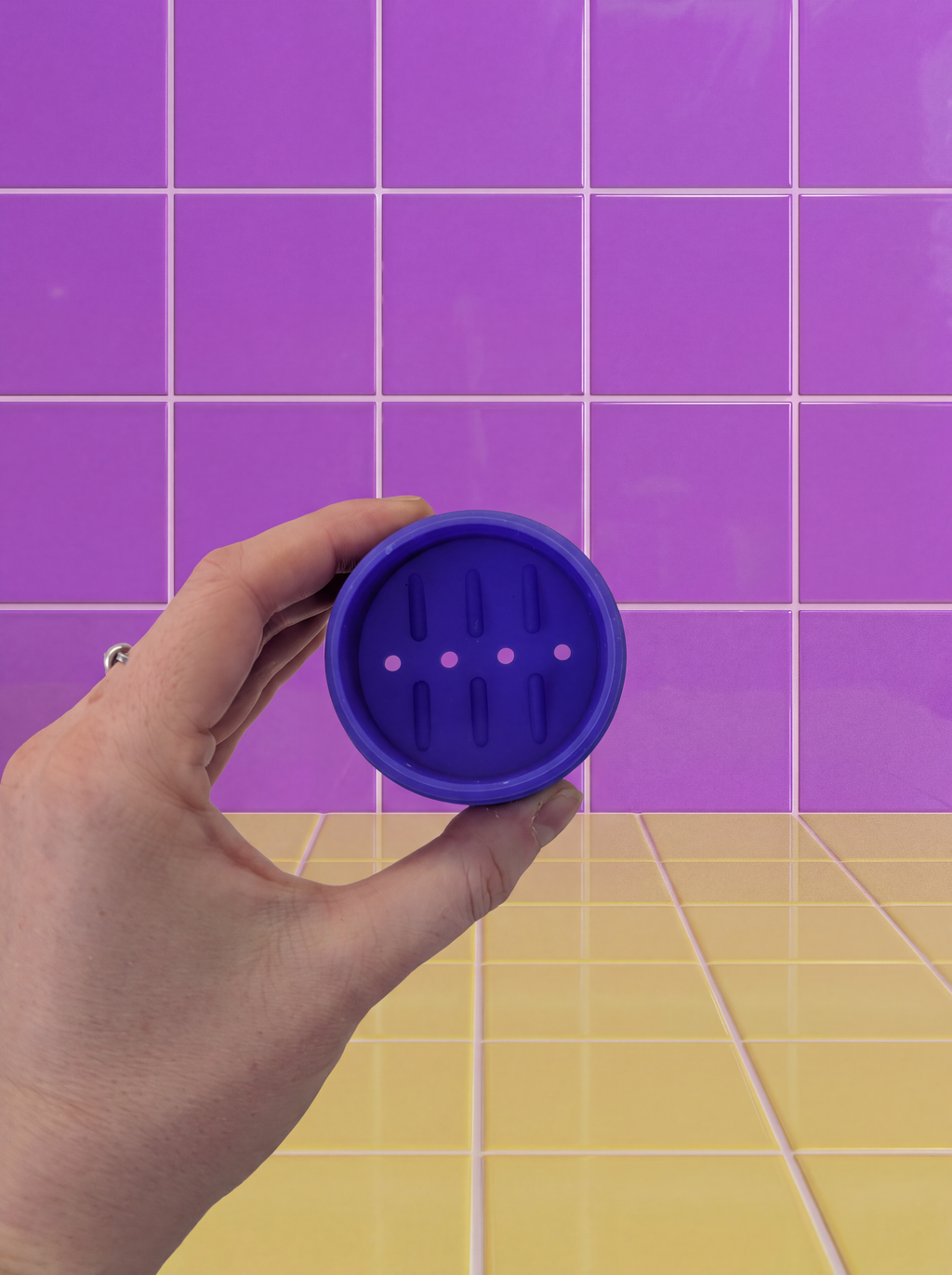 Underside of a purple Mini Just in Case silicone case showing the drainage holes