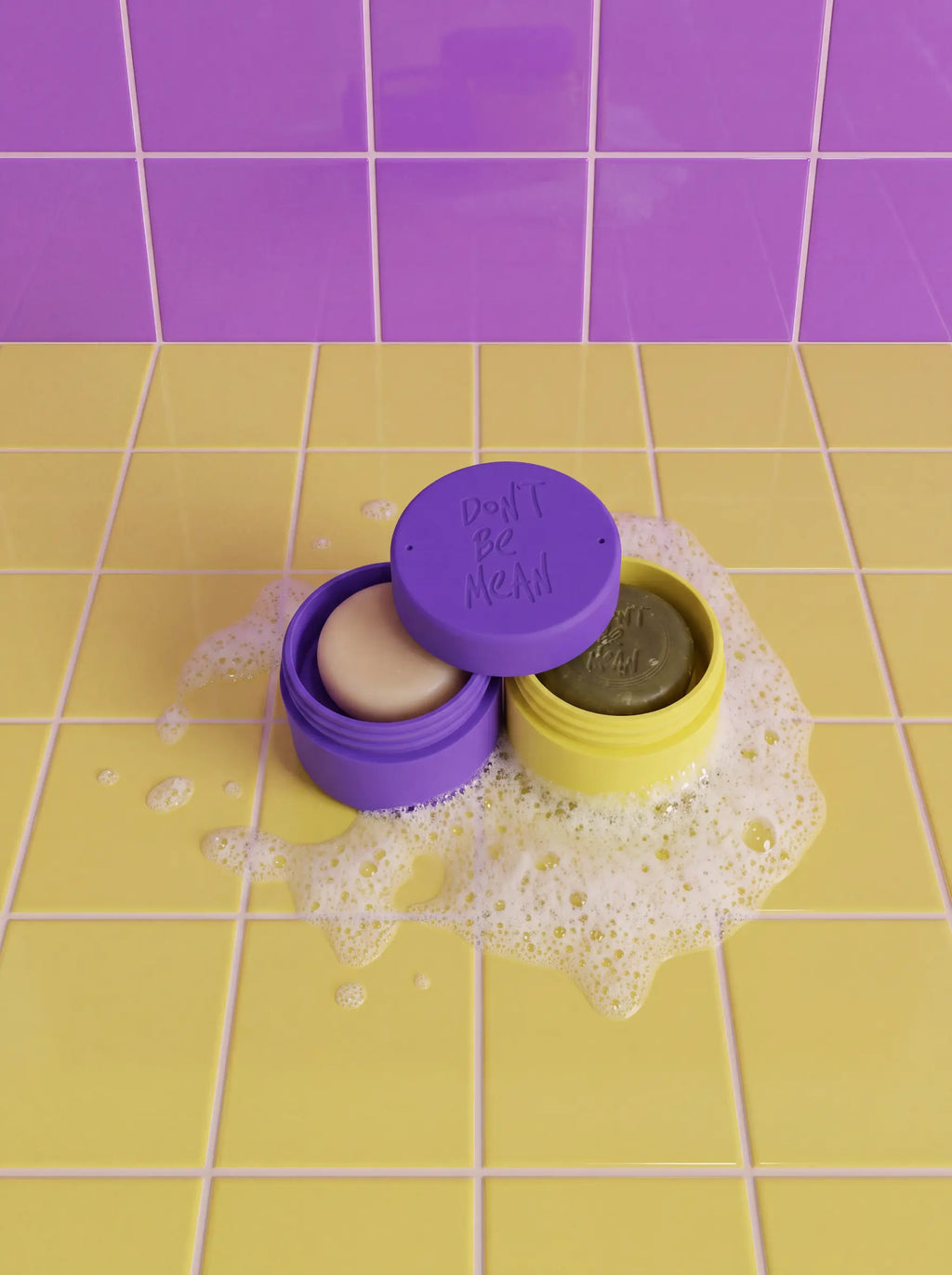 Open purple and yellow silicone travel cases holding a conditioner bar and a shampoo bar in foam